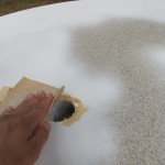 Sand out chipped umbrella hole.