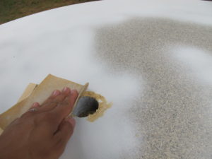 Sand out chipped umbrella hole.